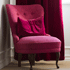 Emma armchair in velvet in front of velvet curtains from ABC Collection.
